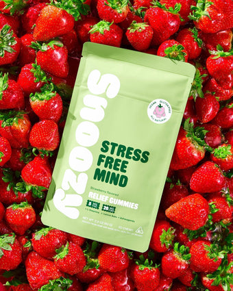 Stress-Free Calm Gummies packaging on a bed of fresh strawberries, showcasing natural stress relief benefits.