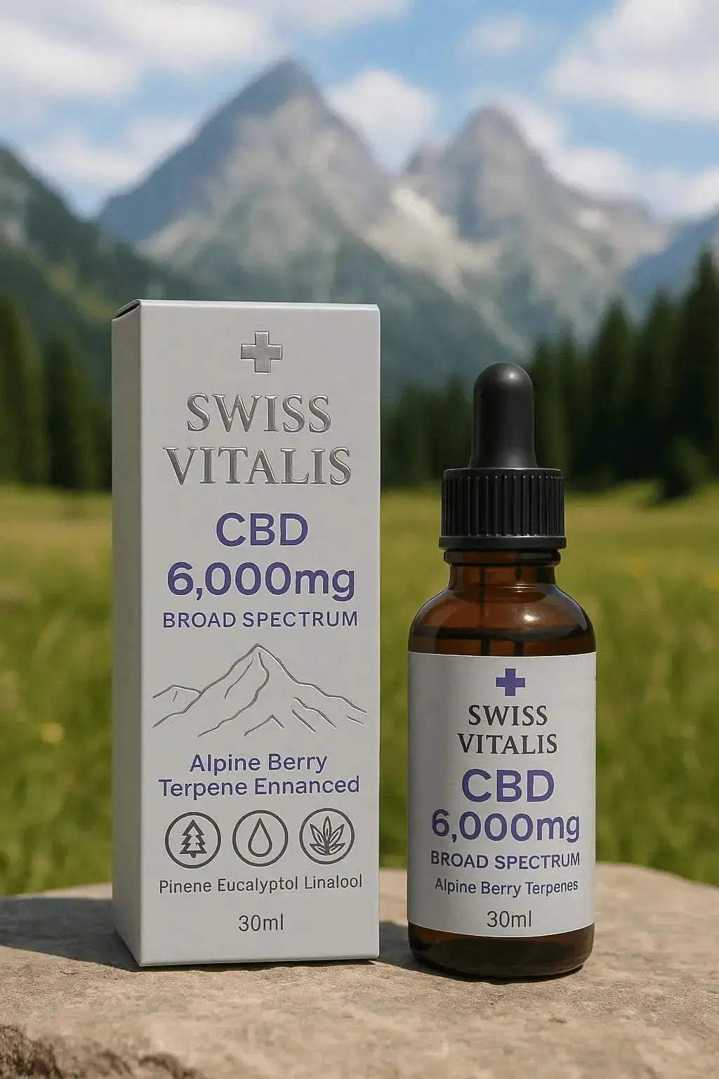 Swiss Vitalis Broad Spectrum CBD Oil 6000mg in amber dropper bottle with white box packaging, displayed outdoors with Swiss Alps mountain backdrop. Premium THC-free CBD tincture enriched with Alpine terpenes including pinene, linalool, eucalyptol, and beta-caryophyllene. Natural hemp extract for relaxation, stress relief, and daily wellness. Vegan, non-GMO, broad-spectrum formula by Swiss Vitalis.